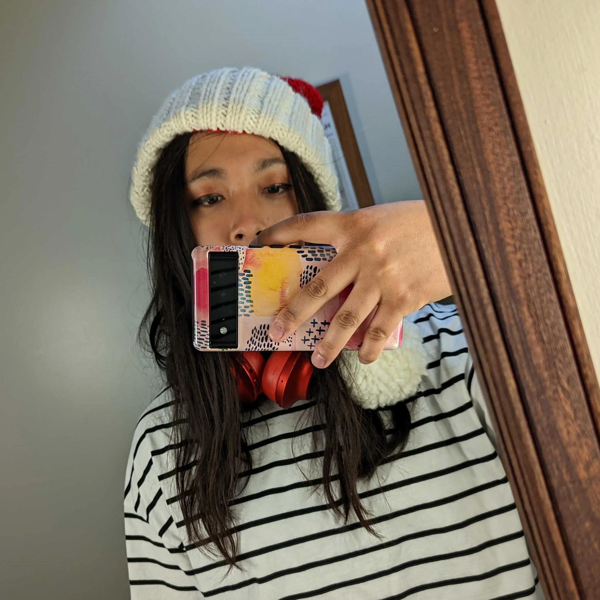 asian girl wearing striped t-shirt and santa hat